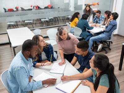 Teacher in class explaining something to a group of students Diploma in Supporting Teaching and Learning with SEN and Inclusive Practice —Test